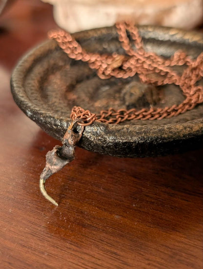 Copper-plated rattlesnake fang pendant with copper chain and dark patina