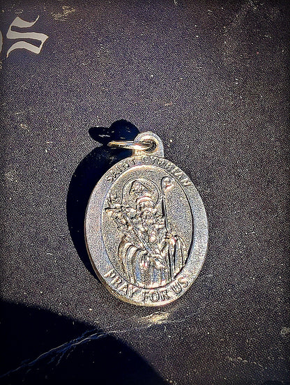 Saint Cyprian medal detail with mysterious black altar cloth