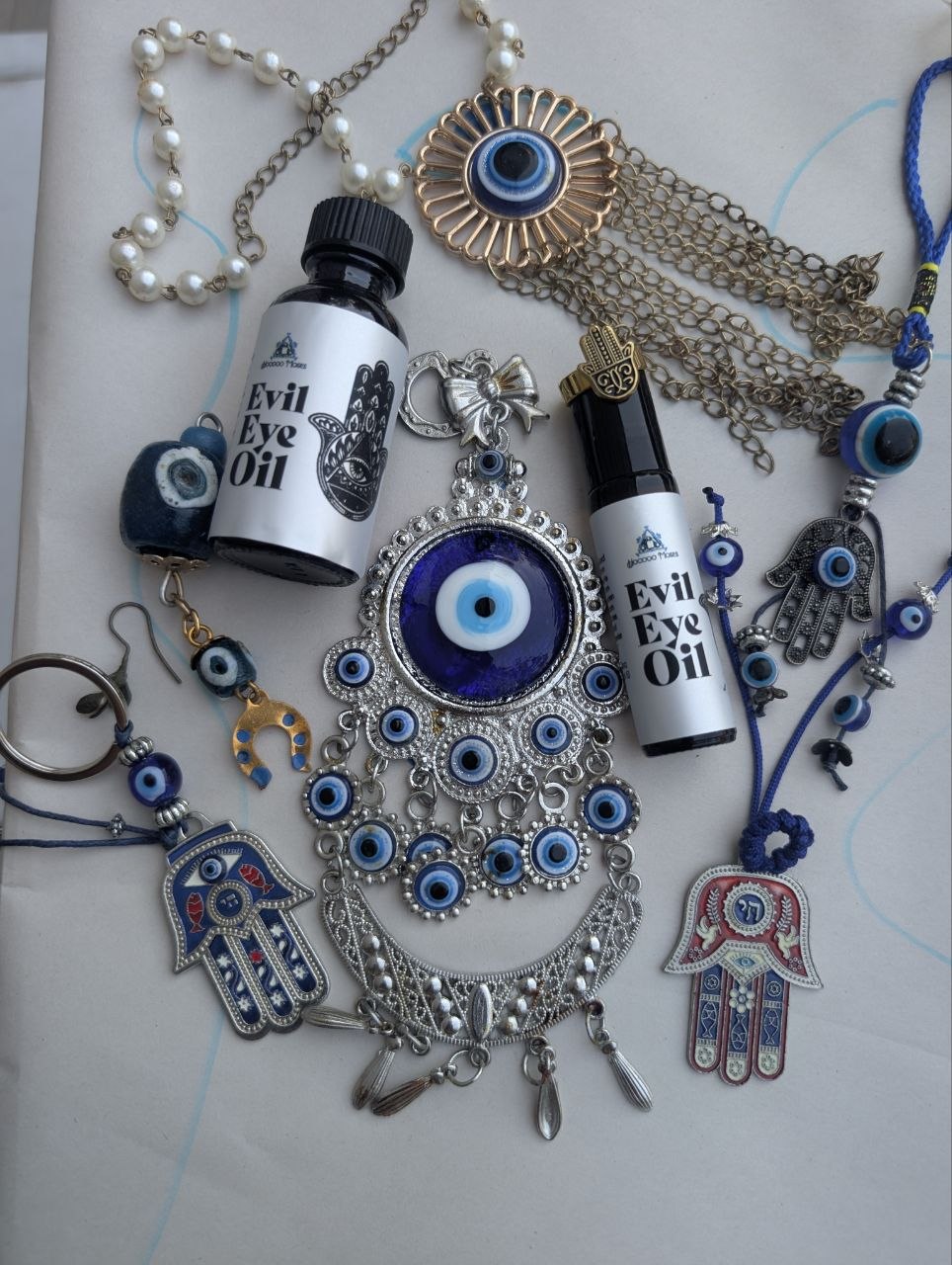 Evil Eye Oil limited drop bottles with protective evil eye charms