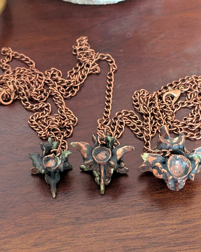 Three python vertebrae pendulums with copper chains